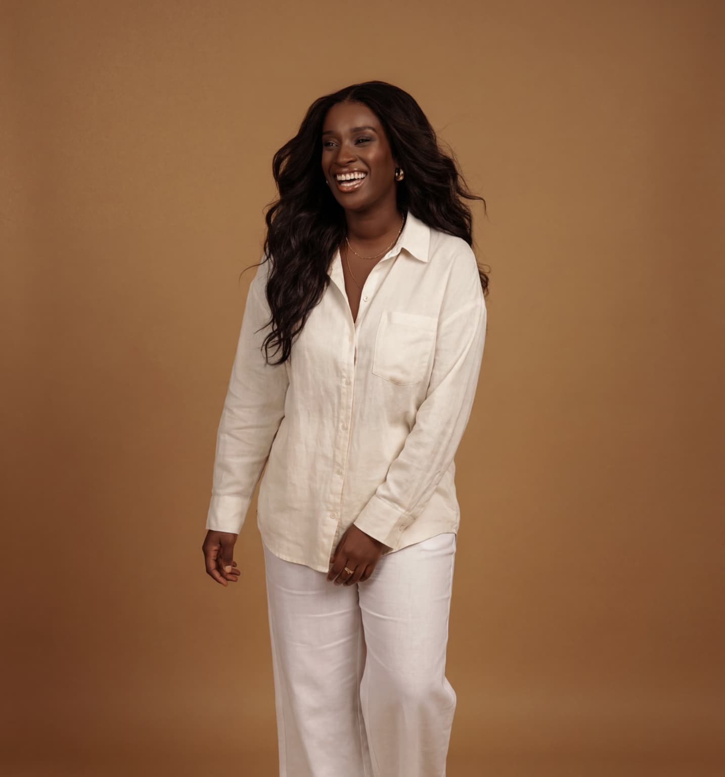 Anne-Tso, recruiter turned career coach, standing in linen